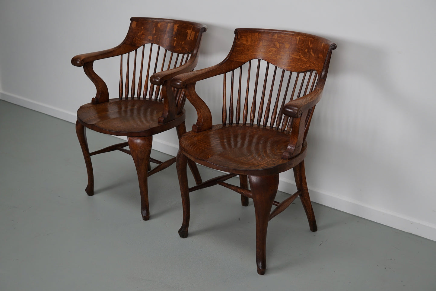 Pair of English Edwardian Oak Spindle Back Captains Office Desk Chairs