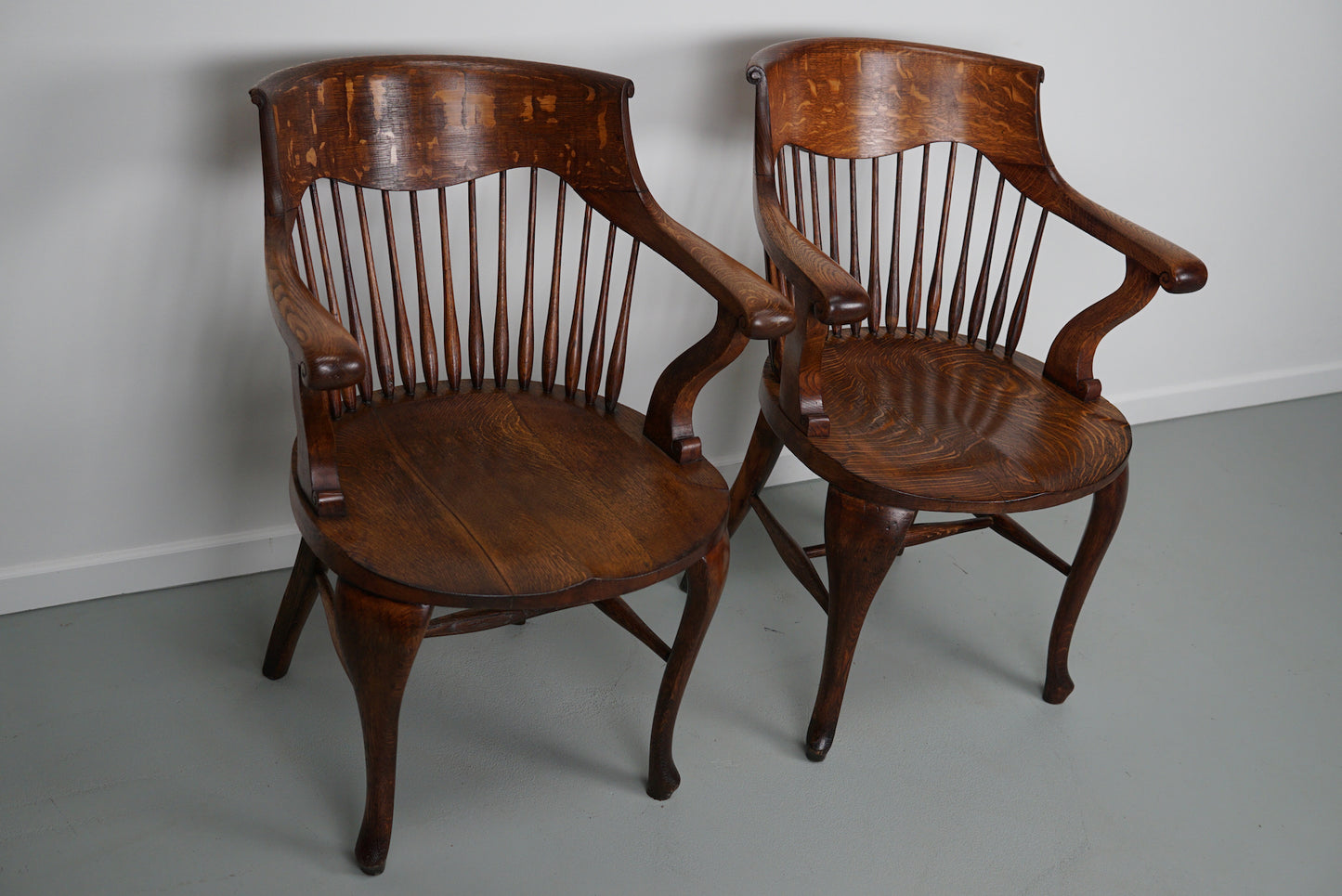 Pair of English Edwardian Oak Spindle Back Captains Office Desk Chairs